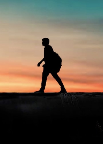 picture of a man walking at dusk